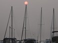 The sun rises over sailboats at the Lakeview Marina in Windsor on Tuesday, July 20, 2021. Southern Ontario is under a special air quality statement from Environment Canada as smoke from forest fires in northwestern Ontario blows southward.