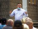 Robert Sandwith, director of housing and programming for Hand in Hand Support in Windsor, speaks to a crowd at the organization's temporary housing facility on Sandwich Street on Thursday, July 22, 2021.