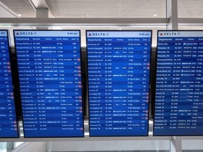 Flight information display screens are seen at the Detroit Metropolitan Wayne County Airport in Detroit, Michigan, U.S. June 12, 2021.