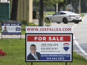 For sale signs are shown on properties along Riverside Drive East in Windsor on Tuesday, July 27, 2021.