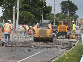 Workers are shown on the Little River Bridge in Windsor on Thursday, July 8, 2021. Riverside Drive East has been shut down in the area for the work.