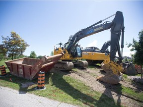 Ready to dig. Heavy machinery parked next to Lakewood Park in Tecumseh in preparation for construction on Manning Road is seen on Friday, July 2, 2021.