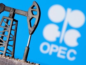 A 3D printed oil pump jack is seen in front of displayed OPEC logo in this illustration picture, April 14, 2020.
