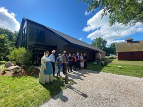 Local leaders, philanthropists, and homesteaders in costume cut the ribbon on the new Heritage and Conservation Centre at the John R. Park Homestead in Essex on July 2, 2021.