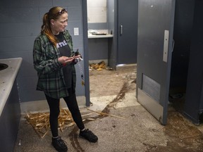 Sarah Hodgkins, a resident at River Place at 245 Detroit St., in Old Sandwich Town, takes a look into the men's community bathroom on Thursday, July 15, 2021. The City of Windsor issued a Prohibition of Occupancy Order and all residents must be out of the building by July 20.