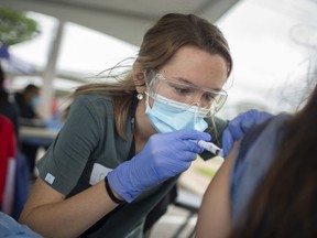 Gemma Fontanin, a nursing student at the University of Windsor, administers a COVID-19 vaccine at a pop-up vaccine clinic in downtown Windsor, on Tuesday, July 13, 2021.