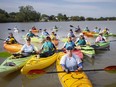 Peggy Hurley, front-centre, captain of the WonderBroads dragon boat team, is pictured with the rest of the dragon boat team on the River Canard before holding a practice, Saturday, July 10, 2021.