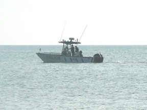 OPP are shown searching Lake Erie at Rondeau Provincial Park on Sunday morning. A 25-year-old man reportedly fell off an inflatable raft on Saturday. (Trevor Terfloth/The Daily News)