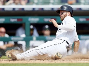 Robbie Grossman of the Detroit Tigers scores from third base on a foul fly out to right fielder Anthony Santander of the Baltimore Orioles during the sixth inning at Comerica Park on August 1, 2021, in Detroit, Michigan.