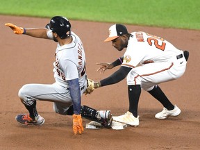 Jeimer Candelario of the Detroit Tigers beats the tag by Jorge Mateo of the Baltimore Orioles for a double in the fourth inning during a baseball game at Oriole Park at Camden Yards on August 11, 2021 in Baltimore, Maryland.