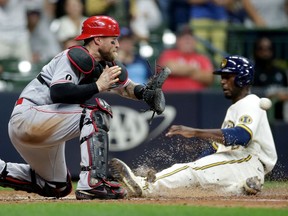 The Detroit Tigers acquired catcher Tucker Barnhart, at left, from the Cincinnati Reds on Wednesday.