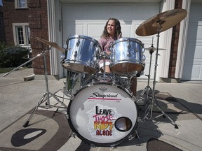 Addi Bonadonna, 11, plays her newly acquired vintage Slingerland drums in front of her home in Windsor on Aug. 30, 2021.