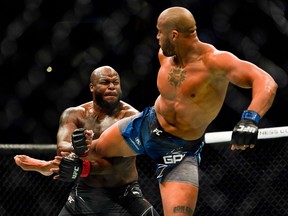 Ciryl Gane kicks Derrick Lewis during their Heavyweight bout at Toyota Center on Aug. 7, 2021 in Houston, Texas.