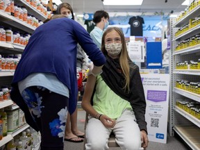 Abby Oplinger, 13, receives the Pfizer-BioNTech COVID-19 vaccine after Pennsylvania authorized the vaccine for those over 12-years-old at Skippack Pharmacy in Schwenksville, Pa., May 12, 2021.