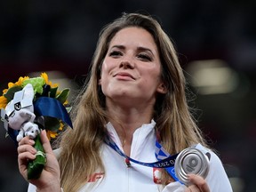Silver medallist Poland's Maria Andrejczyk celebrates on the podium during the victory ceremony for the women's javelin throw event during the Tokyo 2020 Olympic Games at the Olympic Stadium in Tokyo on August 7, 2021.
