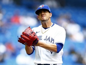Blue Jays starting pitcher Jose Berrios slaps his glove at the end of the second inning during a game against the Royals at Rogers Centre in Toronto, Sunday, Aug. 1, 2021.