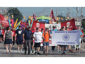 Union members and their families march during the annual Labour Day Parade in 2018 in Windsor. This year's event will be held virtually.