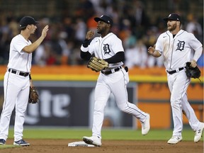 Detroit Tigers shortstop Zack Short (left) and left fielder Akil Baddoo (middle) and right fielder Robbie Grossman celebrate after defeating the Boston Red Sox at Comerica Park on Tuesday, Aug. 3, 2021.