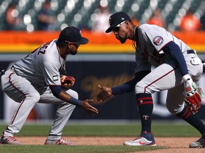 Minnesota Twins centre fielder Byron Buxton (right) celebrates with third baseman Luis Arraez (2) after defeating the Detroit Tigers at Comerica Park.