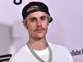 In this file photo Canadian singer Justin Bieber arrives for YouTube Originals' "Justin Bieber: Seasons" premiere at the Regency Bruin Theatre in Los Angeles on January 27, 2020.