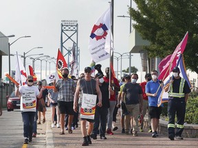 Members of the Customs and Immigration Union and their supporters participate in a rally near the Ambassador Bridge in Windsor on Wednesday, August 4, 2021.