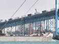 Transport trucks line the Ambassador Bridge on Aug. 6, 2021.