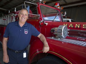 Kingsville Fire Chief, John Quennell, stands next to a vintage 1966 Maxim S fire truck from Hanson Massachusetts, at the Kingsville fire hall, on Tuesday, August 31, 2021.