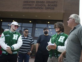 Those opposed to the postponing of the high school football season gather outside the Greater Essex County District School Board administration office on Thursday, August 26, 2021.