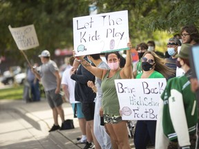 People participate in a rally opposing to the cancellation of the high school football season, while outside Kennedy Collegiate on Monday, August 30, 2021.