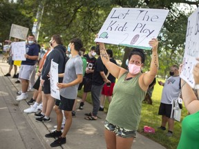 People participate in a rally opposing to the cancellation of the high school football season, while outside Kennedy Collegiate on Monday, August 30, 2021.