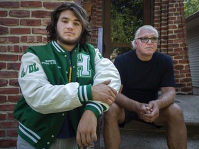 Dean Facca, 16, a grade 11 student at Herman Secondary School, is pictured with his father, Gino Facca, outside their home on Monday, August 23, 2021.  The father and son are upset the high school football season may be postponed.