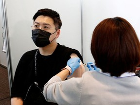 A man receives the Moderna coronavirus vaccine at the Tokyo Metropolitan Government building in Tokyo, Japan June 25, 2021.