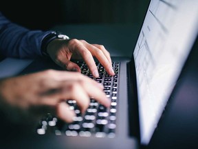 File photo of hands using a laptop.