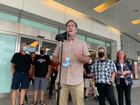 Windsor West MP Brian Masse speaks at an entrance to Caesars Windsor with members of Unifor Local 444 behind him on Aug. 27, 2021.