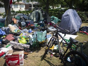 Tents and personal belongings fill the front yard of the recently condemned River Place in Sandwich Town on Thursday, August 5, 2021, as evicted tenants struggle to find places to live.
