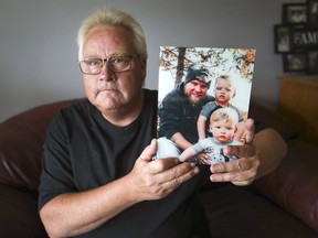 Phil Janisse poses with a photo of his son Matt and his grandchildren Oliver and Theodore at his Windsor home on Monday, August 16, 2021. Matt died by suicide in January 2021.