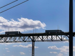 Transport trucks cross the Windsor-Detroit border via the Ambassador Bridge in this April 2021 file photo.