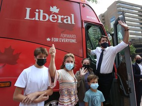 Prime Minister Justin Trudeau (R), his wife Sophie Gregoire Trudeau and their children Xavier (L-R), Ella-Grace and Hadrien waves to supporters while boarding his campaign bus on August 15, 2021 in Ottawa.