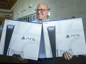 Mayor Drew Dilkens holds two brand new PlayStation 5's which can be won as part of the WEVaxToWin program, while in the lobby to City Hall on Wednesday, August 25, 2021.