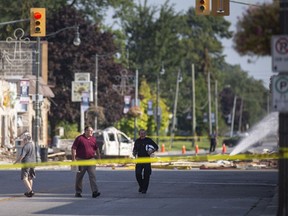 Officials survey the wreckage from a gas explosion on Erie St. North in Wheatley on Friday, August 27, 2021.