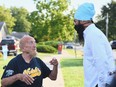Jagmeet Singh, the federal NDP leader, spoke to David Cawthorne, a resident at Iler Lodge, following a campaign stop outside the home on Wednesday, Sept. 15, 2021. Singh outlined his party's plans to transition away from for-profit long-term care homes if elected.