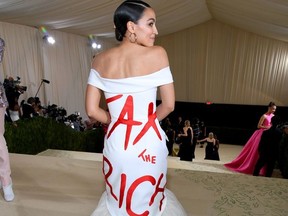 Alexandria Ocasio-Cortez attends the Met Gala on Sept. 13, 2021 wearing white dress with the words "Tax the Rich" across the back.