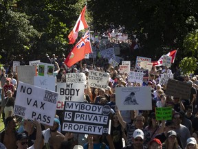 A crowd begins a march following a demonstration to protest measures taken by public health authorities to curb the spread of COVID-19, in Toronto, Saturday, Sept. 18, 2021.