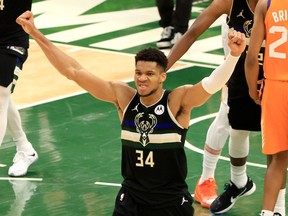 Giannis Antetokounmpo #34 of the Milwaukee Bucks celebrates in the final second before defeating the Phoenix Suns in Game Six to win the 2021 NBA Finals at Fiserv Forum on July 20, 2021 in Milwaukee, Wisconsin.