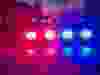 Lights of police car in night time. Night patrolling the city, lights flashing. Abstract blurry image.