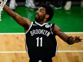 Nets' Kyrie Irving drives to the basket against the Celtics during the NBA's Eastern Conference first round series at TD Garden in Boston, May 30, 2021.
