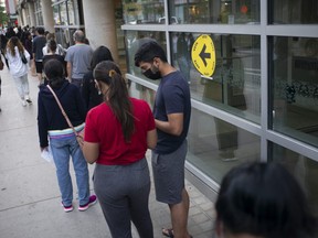 Voters line up at the Toronto Reference Library to vote in the Toronto Centre riding on Sept. 20, 2021 in Toronto.