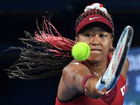 Naomi Osaka returns the ball to Marketa Vondrousova during their Tokyo 2020 Olympic Games match at the Ariake Tennis Park in Tokyo on July 27, 2021.