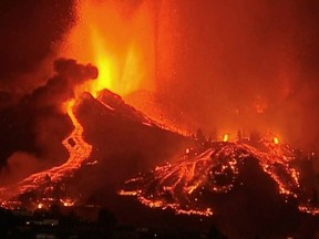 Lava pours out of a volcano in the Cumbre Vieja national park at El Paso, on the Canary Island of La Palma, September 19, 2021, in this screen grab taken from a video. FORTA/Handout via REUTERS