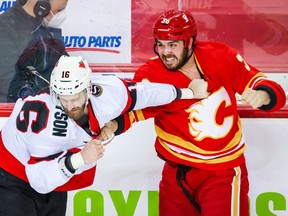 Calgary Flames left wing Zac Rinaldo (36) and Ottawa Senators left wing Austin Watson (16) fight at Scotiabank Saddledome